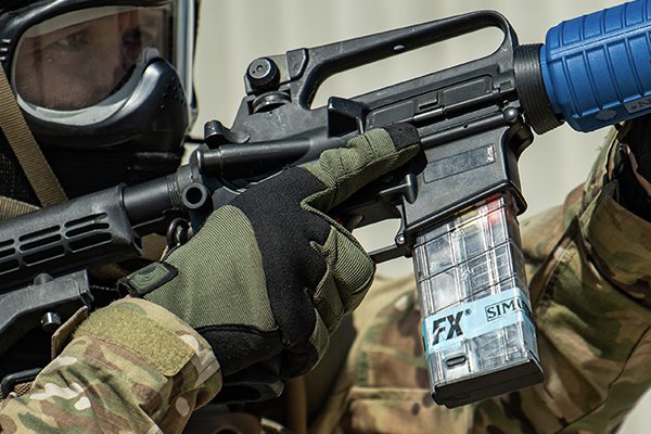 A close-up image of an military officer aiming his FX training weapon