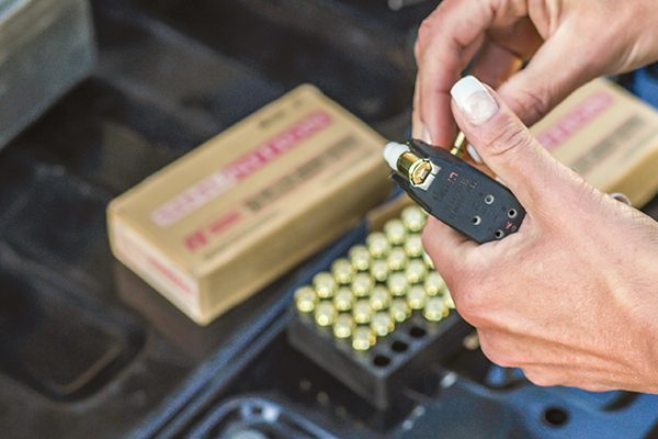 A female officer loading FX training cartridges into a magazine