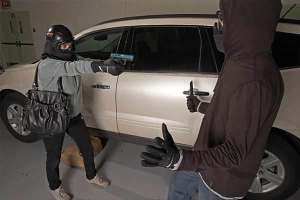 An image of a woman wearing FX protective equipment pointing a training weapon towards an attacker during a training an exercise